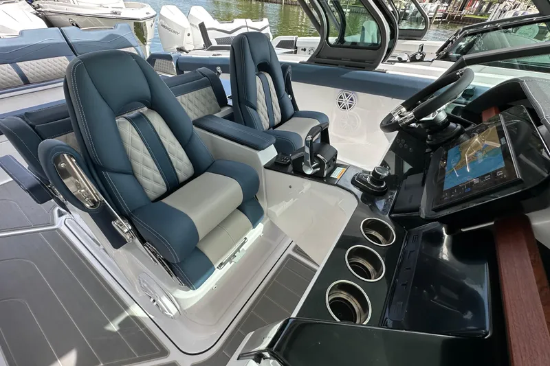 Slide: The Image of Luxurious cockpit of 2026 Monterey Elite 30 OB boat with plush seating and advanced controls. - 10