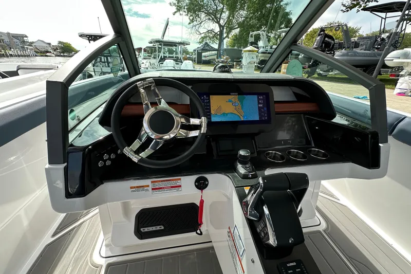Slide: The Image of 2026 Monterey Elite 30 OB boat dashboard with steering wheel and navigation display. - 11
