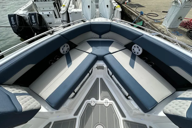 Slide: The Image of Luxurious seating on 2026 Monterey Elite 30 OB boat, featuring blue and white upholstery. - 13