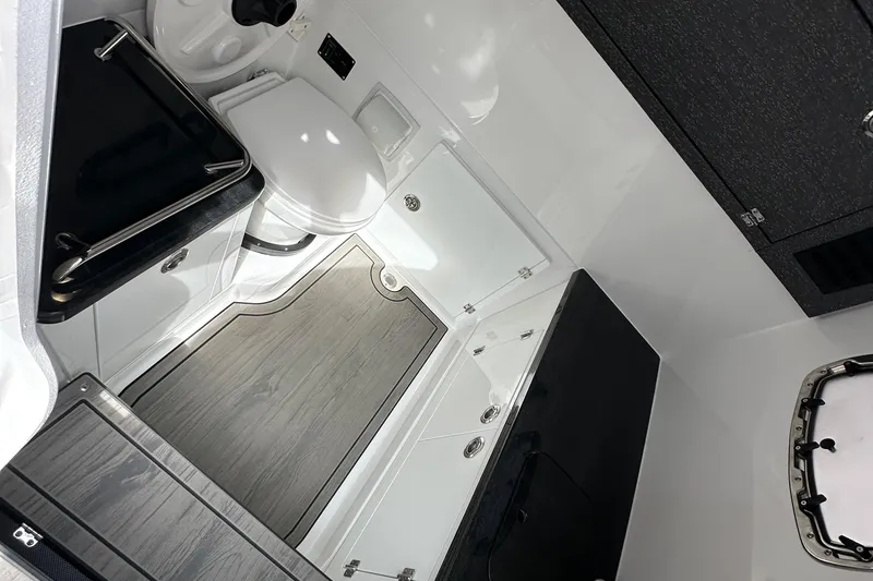 Slide: The Image of Interior of 2026 Monterey Elite 30 OB boat bathroom with modern fixtures and wood flooring. - 15