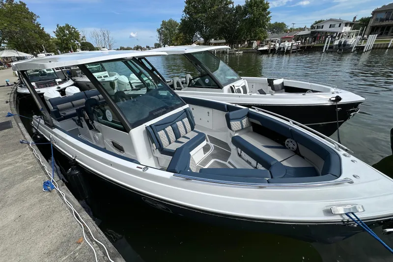 Slide: The Image of 2026 Monterey Elite 30 OB boat docked, featuring sleek design and spacious seating. - 3