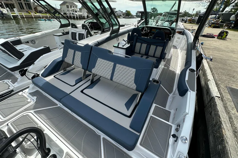 Slide: The Image of 2026 Monterey Elite 30 OB boat with luxurious seating and modern design docked by the water. - 7