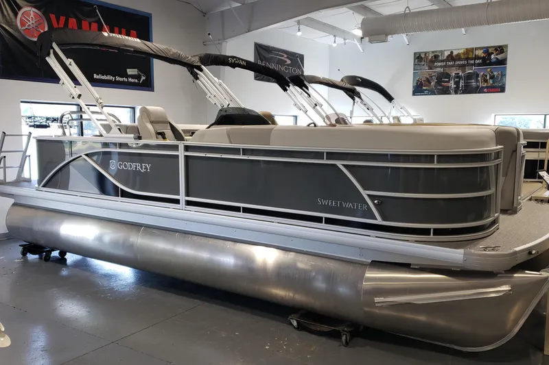 The Image of 2026 Godfrey 2086C SE pontoon boat in showroom, featuring sleek design and modern amenities. - 0