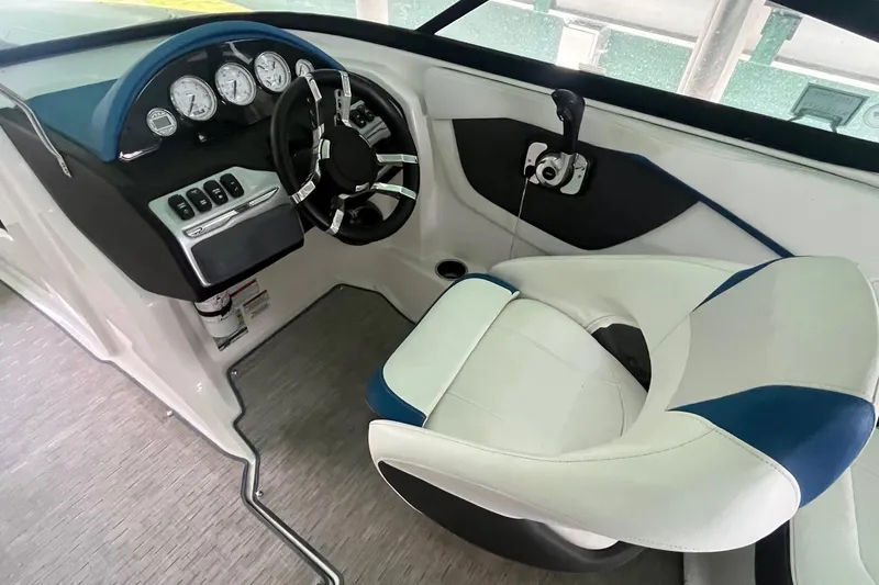 Slide: The Image of 2016 Regal 22 FasDeck ESX boat cockpit with steering wheel and control panel. - 15
