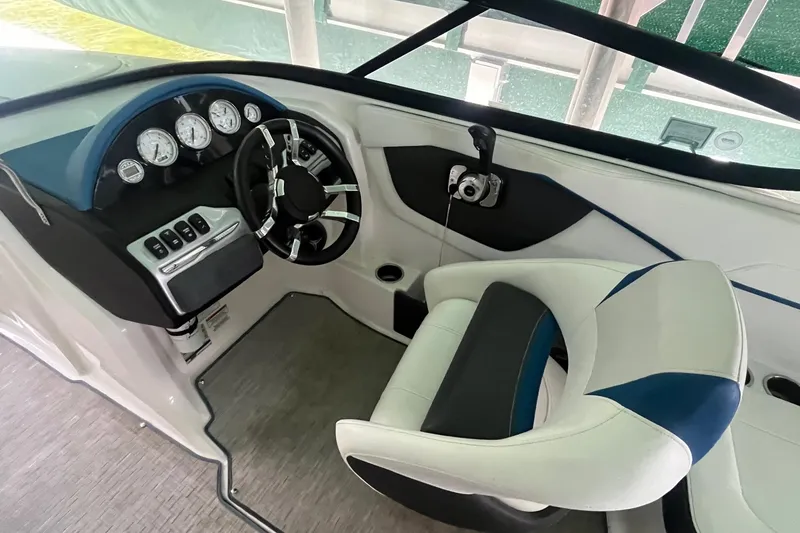 Slide: The Image of 2016 Regal 22 FasDeck ESX boat interior with steering wheel and gauges. - 16