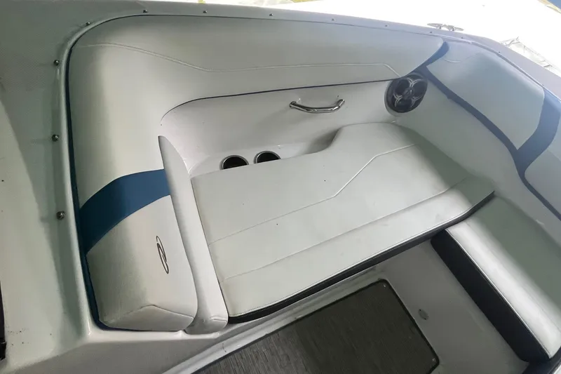 Slide: The Image of 2016 Regal 22 FasDeck ESX boat interior with white seating and blue accents. - 21