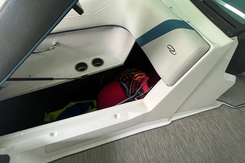 Slide: The Image of 2016 Regal 22 FasDeck ESX boat interior storage compartment with seat and accessories. - 22