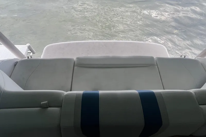 Slide: The Image of 2016 Regal 22 FasDeck ESX boat interior with cushioned seating and water view. - 28