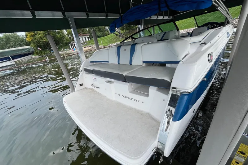 Slide: The Image of 2016 Regal 22 FasDeck ESX boat docked, featuring spacious seating and sleek design. - 7