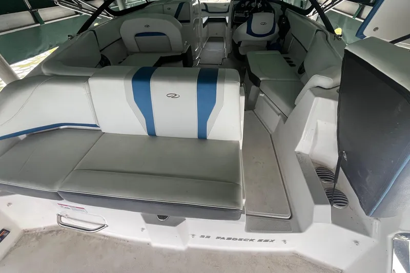 Slide: The Image of 2016 Regal 22 FasDeck ESX boat interior with white and blue seating. - 8