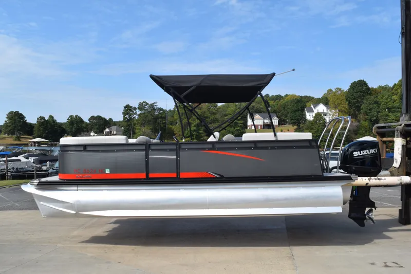 The Image of 2023 Qwest E Class-820 RLS-Lt pontoon boat with Suzuki motor, docked outdoors. - 1