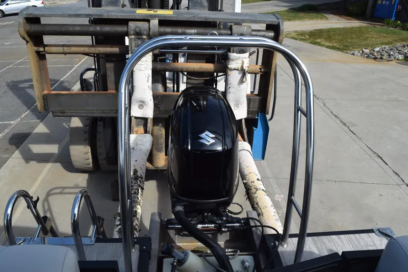 Slide: The Image of 2023 Qwest E Class-820 RLS-Lt boat with Suzuki outboard motor on a forklift. - 17