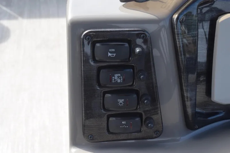 Slide: The Image of Control panel of 2023 Qwest E Class-820 RLS-Lt with switches for horn, lights, and accessories. - 9