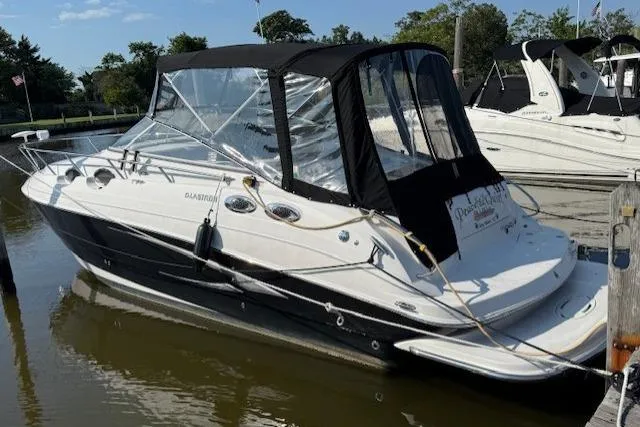 Slide: The Image of 2013 Glastron GS 289 boat docked in marina, featuring black and white design. - 1