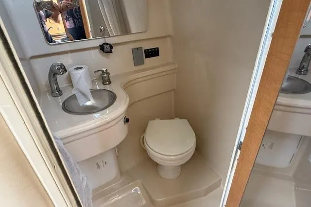 Slide: The Image of 2013 Glastron GS 289 boat bathroom with sink, toilet, and mirror. - 13