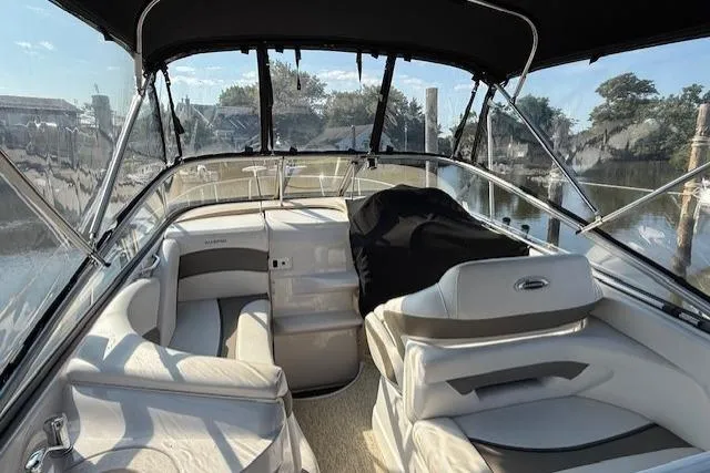 Slide: The Image of 2013 Glastron GS 289 boat interior with seating, canopy, and steering wheel. - 3