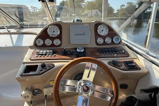 Slide: The Image of 2013 Glastron GS 289 boat dashboard with Garmin navigation system and wooden steering wheel. - 4