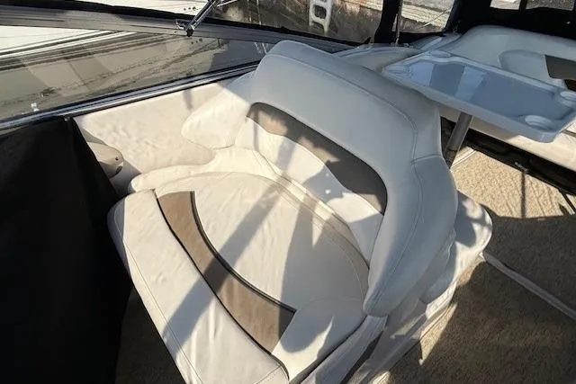 Slide: The Image of 2013 Glastron GS 289 boat interior with beige seating and table. - 5