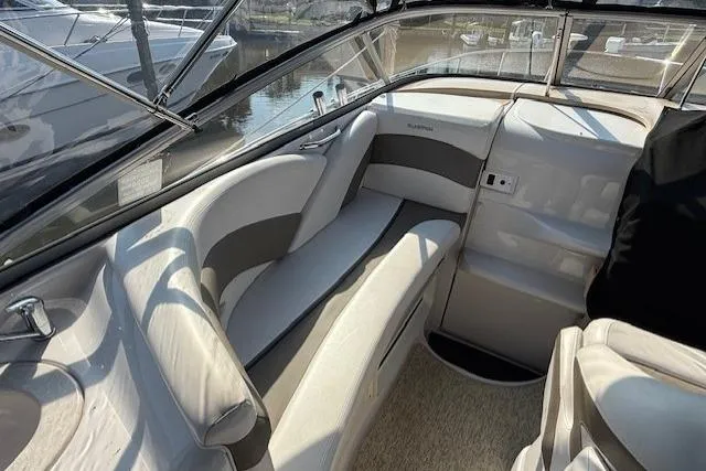 Slide: The Image of Interior of a 2013 Glastron GS 289 boat with beige seating and windows. - 6