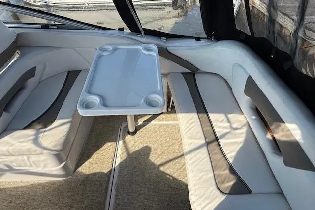 Slide: The Image of Interior of 2013 Glastron GS 289 boat with seating and table setup. - 8