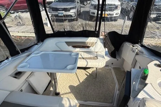 Slide: The Image of Interior of 2013 Glastron GS 289 boat with seating and table setup. - 9
