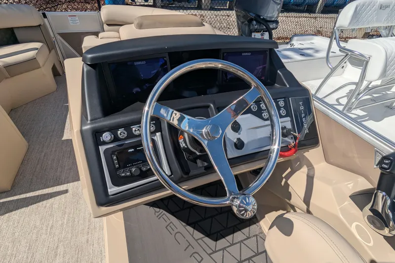 Slide: The Image of 2026 Trifecta 25 RFC SS boat dashboard with steering wheel and control panel. - 3