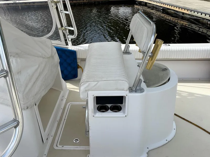 Slide: The Image of 2005 Strike 35 Sportfisherman boat interior with seating and cup holders by the water. - 13