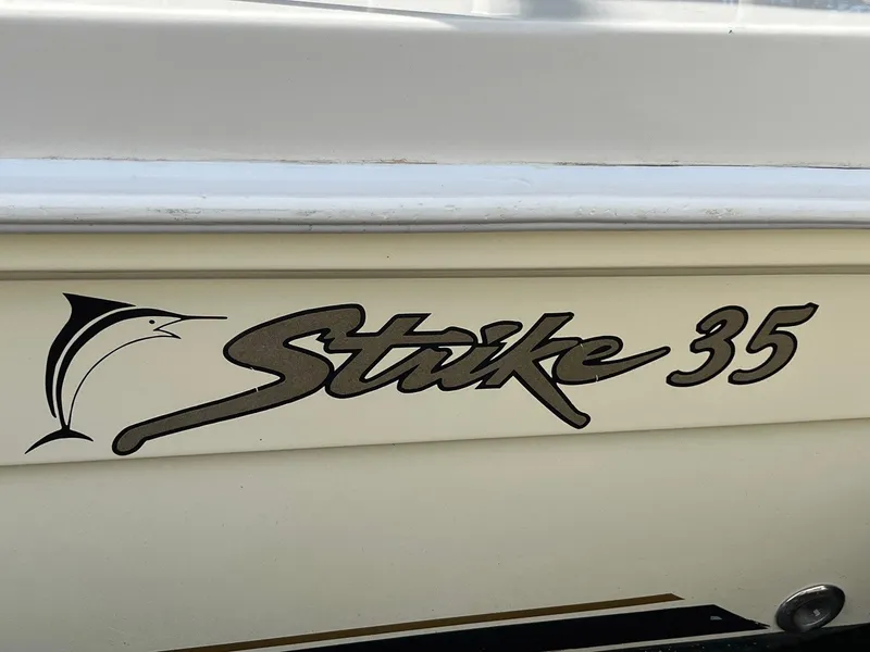 Slide: The Image of Strike 35 Sportfisherman 2005 boat logo on hull, featuring marlin graphic. - 25