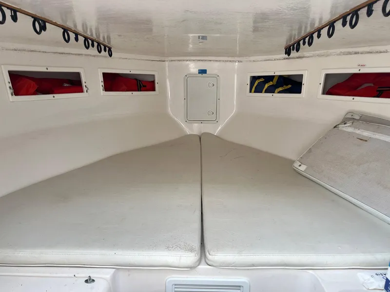 Slide: The Image of 2005 Strike 35 Sportfisherman cabin interior with cushioned seating and storage compartments. - 3