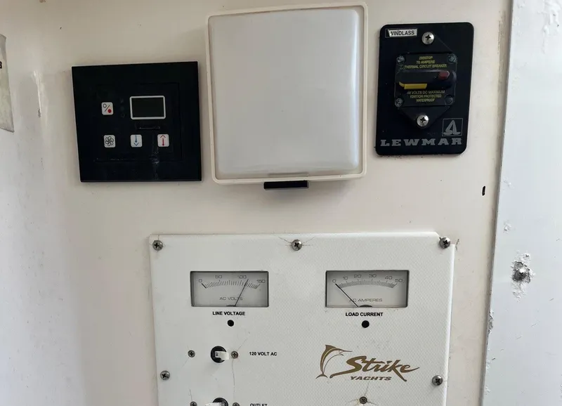 Slide: The Image of Control panel of a 2005 Strike 35 Sportfisherman yacht with voltage and current gauges. - 4