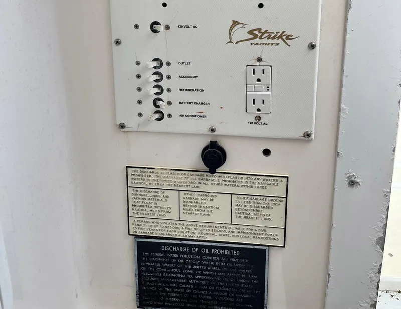 Slide: The Image of Control panel of 2005 Strike 35 Sportfisherman with outlets and warning labels. - 5