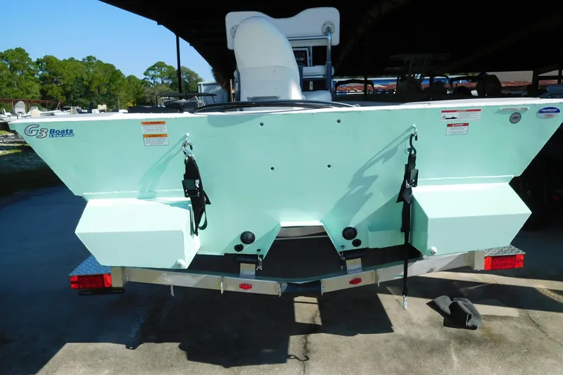 Slide: The Image of 2025 G3 Bay 21 GX Tunnel boat rear view on trailer, light blue color. - 1