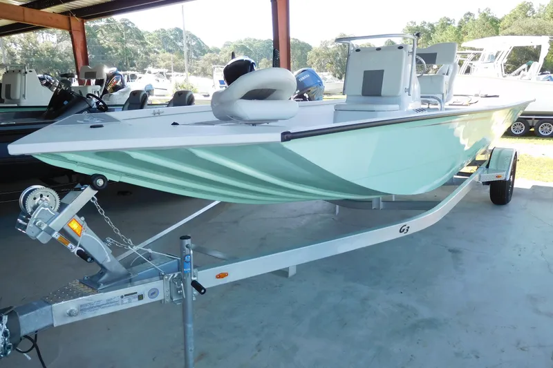 Slide: The Image of 2025 G3 Bay 21 GX Tunnel boat on trailer in covered storage area. - 2