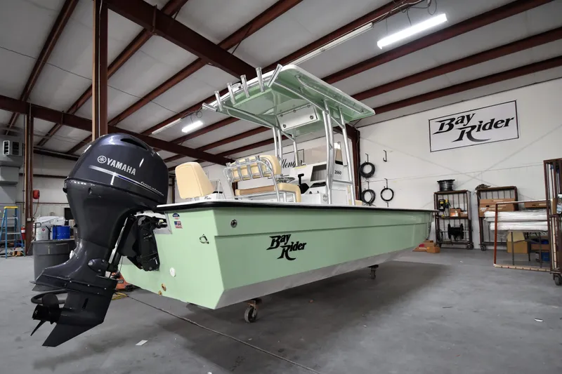 Slide: The Image of 2024 KenCraft 2060 Bay Rider Skiff in a warehouse with Yamaha outboard motor. - 16