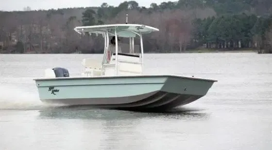 Slide: The Image of 2024 KenCraft 2060 Bay Rider Skiff cruising on a lake. - 3