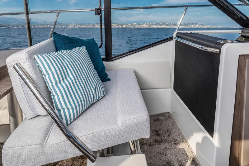 Slide: The Image of Interior of 2026 Jeanneau NC 895 Series 2 boat with striped cushions and ocean view. - 6