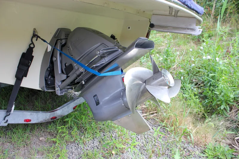 Slide: The Image of 2017 Chris-Craft Capri 27 boat with blue cover, parked outdoors. - 10