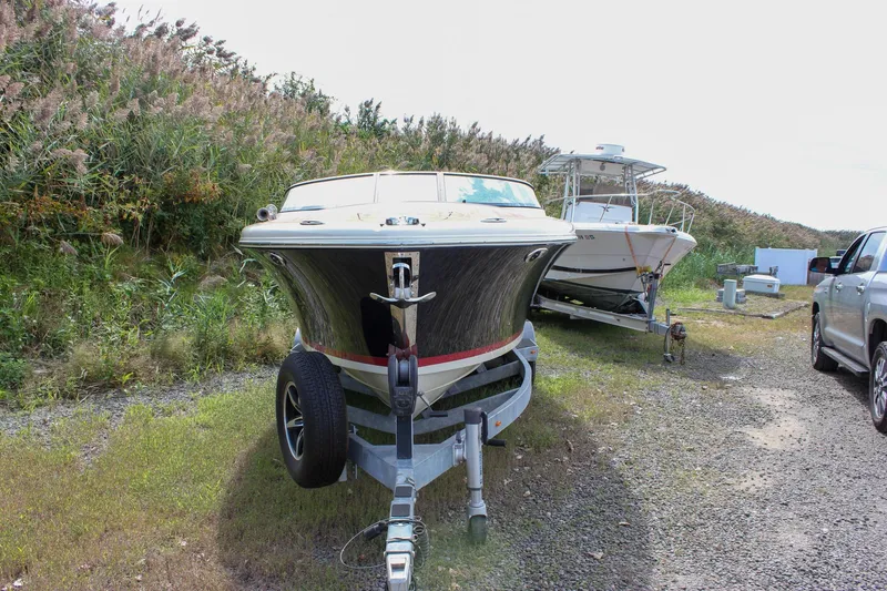 Slide: The Image of 2017 Chris-Craft Capri 27 boat engine and propeller, secured with a blue strap. - 12