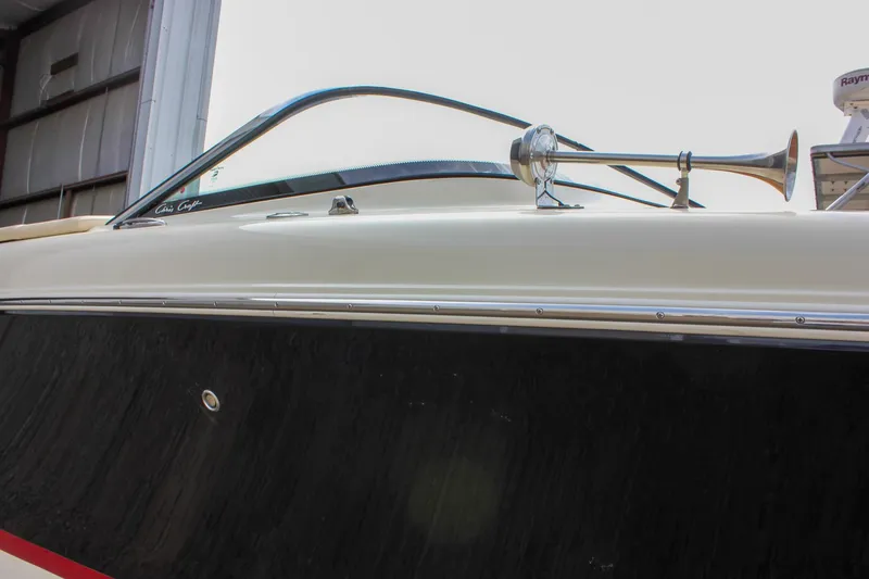 Slide: The Image of 2017 Chris-Craft Capri 27 with sleek wooden deck and elegant design. - 16