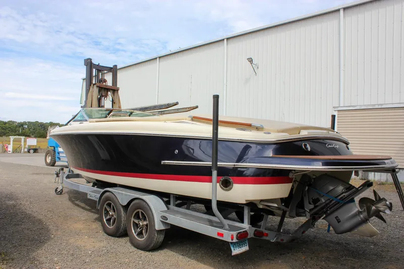 Slide: The Image of 2017 Chris-Craft Capri 27 boat on trailer, rear view with propeller and ladder. - 21