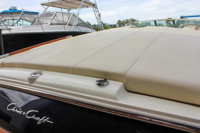 Slide: The Image of 2017 Chris-Craft Capri 27 boat with sleek design and wooden deck. - 22