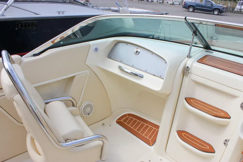 Slide: The Image of Luxurious interior of 2017 Chris-Craft Capri 27 boat with cream leather seating. - 26