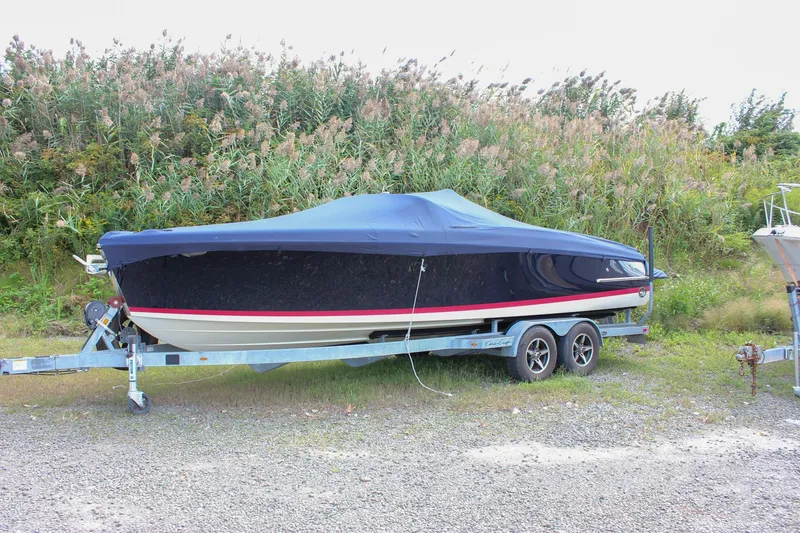 Slide: The Image of 2017 Chris-Craft Capri 27 boat in showroom, showcasing elegant design and wood detailing. - 3