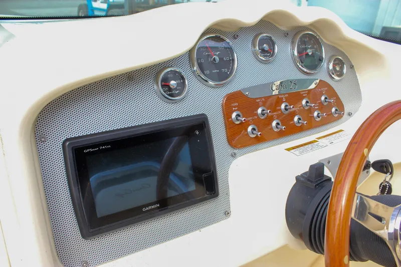 Slide: The Image of 2017 Chris-Craft Capri 27 boat interior with Volvo Penta controls and steering wheel. - 32
