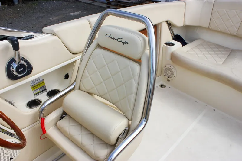 Slide: The Image of Dashboard of 2017 Chris-Craft Capri 27 boat with gauges and control switches. - 33