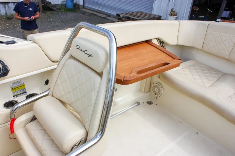 Slide: The Image of 2017 Chris-Craft Capri 27 interior with cream leather seats and chrome accents. - 35
