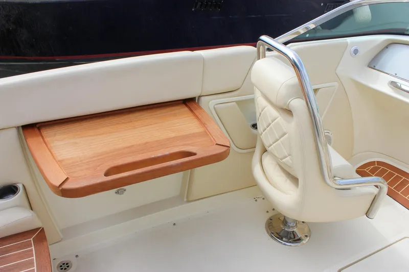 Slide: The Image of 2017 Chris-Craft Capri 27 boat with beige quilted upholstery and a chrome fixture. - 36