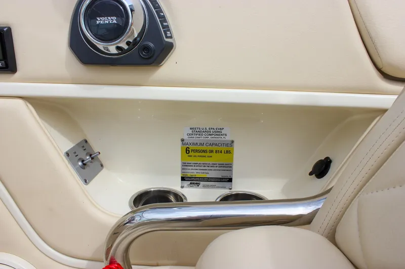 Slide: The Image of 2017 Chris-Craft Capri 27 interior with wooden table and cream leather seating. - 38