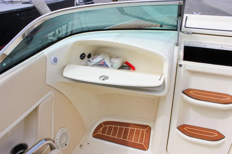 Slide: The Image of Luxurious interior of 2017 Chris-Craft Capri 27 with cream leather seating and wooden flooring. - 39