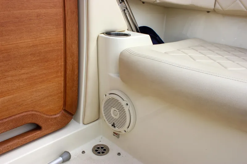 Slide: The Image of 2017 Chris-Craft Capri 27 interior with storage compartment and wooden accents. - 41